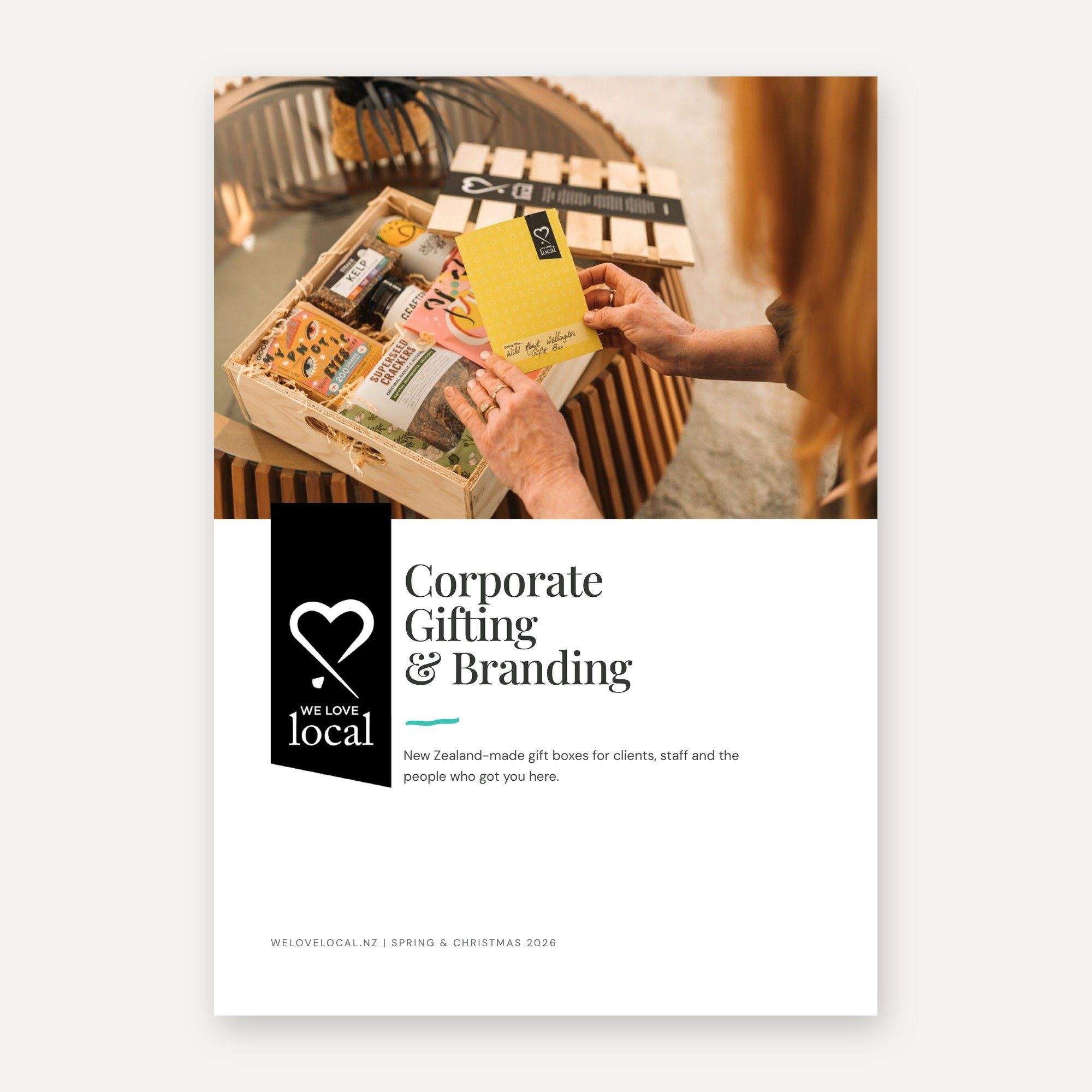 Cover of the We Love Local Corporate Gifting and Branding catalogue for spring and Christmas 2026, showing hands opening a wooden gift crate of New Zealand-made treats